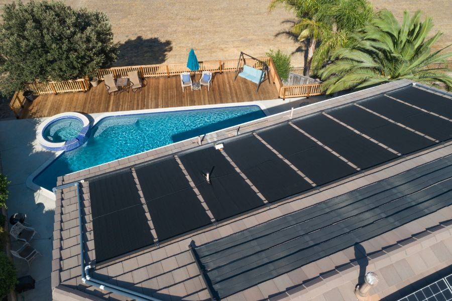 Home solar pool heater with solar panels installed on the roof